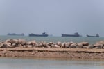 Vessels navigating near Bandar Abbas in the Strait of Hormuz as Iran claims command authority over the strategic waterway