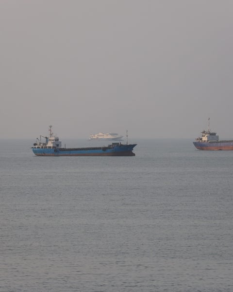 Commercial vessels transiting the Strait of Hormuz near Bandar Abbas, Iran, as US-Iran talks unfold in Doha