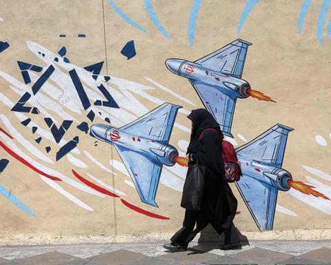 A woman walks past an anti-Israeli mural in Tehran, Iran, June 2026, during the ongoing Iran-Israel conflict