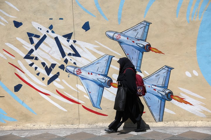 A woman walks past an anti-Israeli mural in Tehran, Iran, June 2026, during the ongoing Iran-Israel conflict