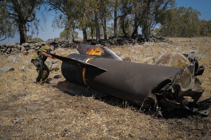 Israeli soldier examines wreckage of an Iranian missile intercepted during the US-Iran war, July 2026