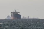 An oil tanker transits the Strait of Hormuz, through which Iran's crude exports surged under the MoU sanctions waiver