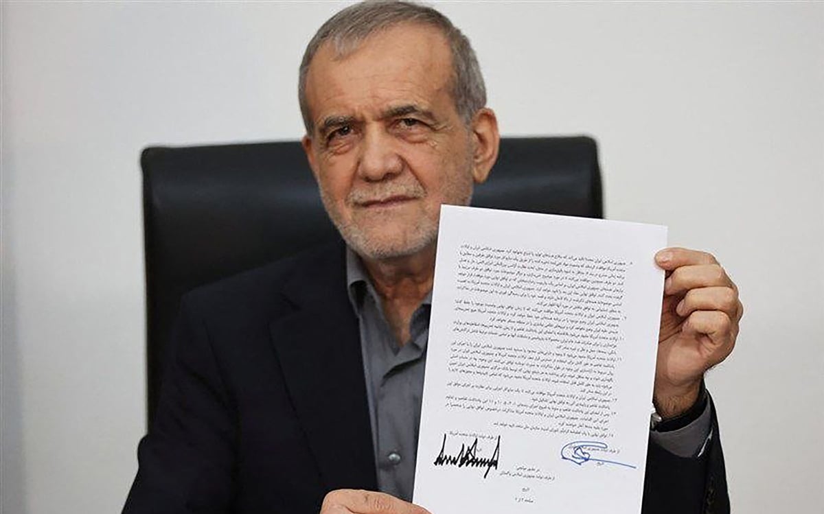 Iran President Masoud Pezeshkian displaying the memorandum of understanding signed to end the 2026 Iran-US war