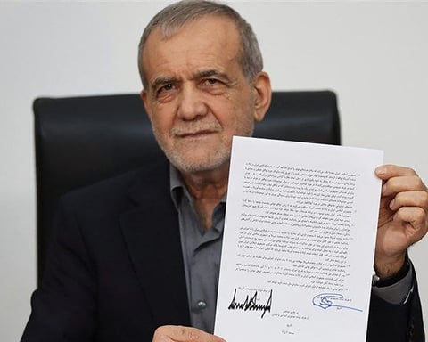 Iran President Masoud Pezeshkian displaying the memorandum of understanding signed to end the 2026 Iran-US war