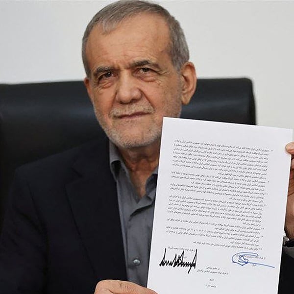 Iran President Masoud Pezeshkian displaying the memorandum of understanding signed to end the 2026 Iran-US war