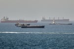 Rescue boats approach burning oil tankers in the Strait of Hormuz as the US carried out its tenth night of strikes on Iran