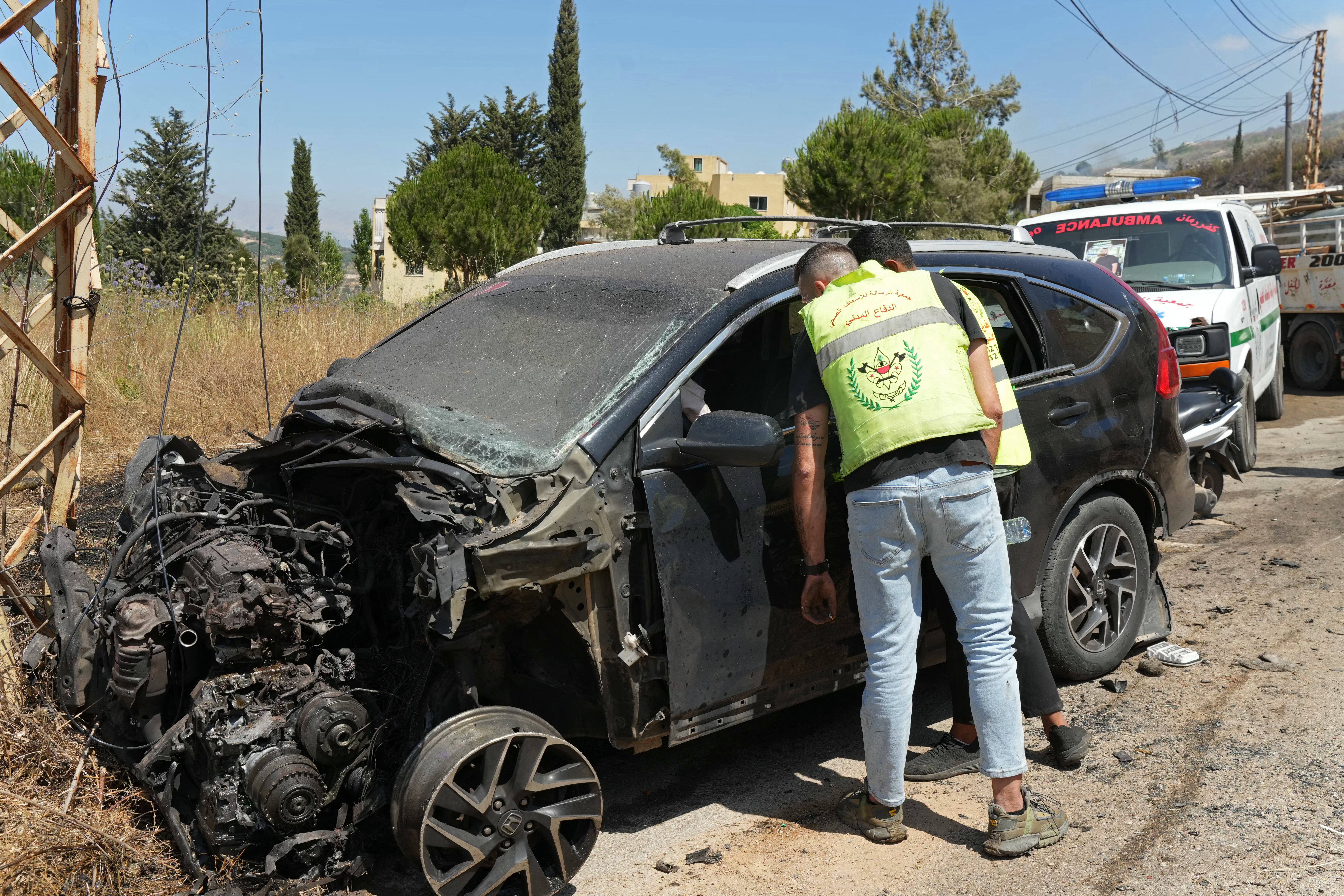 First responders inspect a vehicle damaged by Israeli drone strike in Kfar Reman southern Lebanon July 10 2026