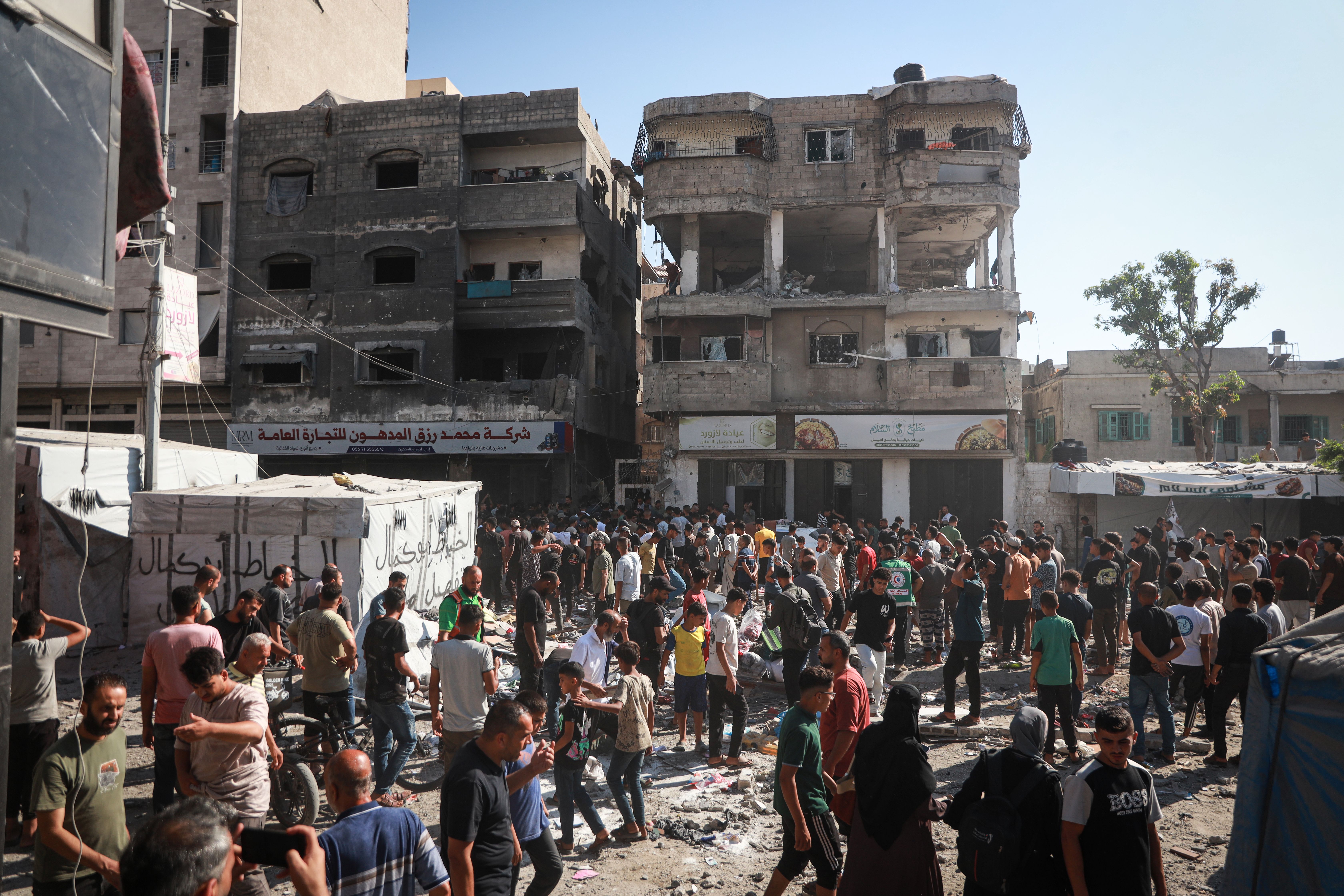 Rescue workers search rubble after Israeli strikes killed three children from one family in Gaza City