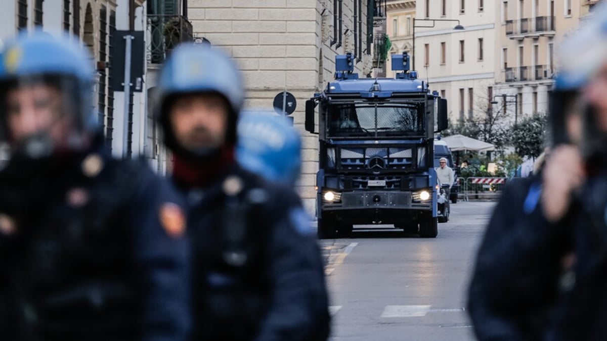 Italian police officers during arrest operation in northern Italy amid nationwide youth crime crackdown