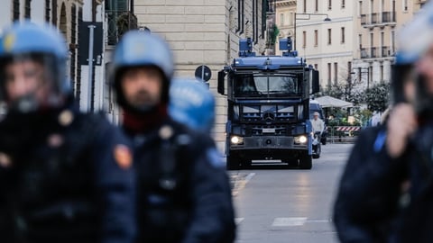 Italian police officers during arrest operation in northern Italy amid nationwide youth crime crackdown