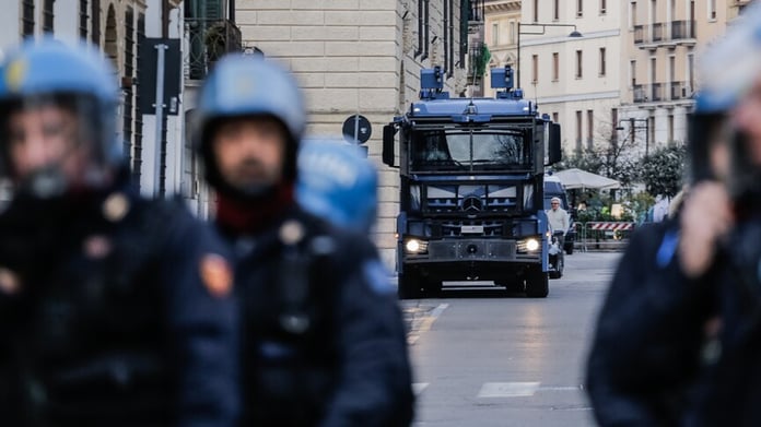 Italian police officers during arrest operation in northern Italy amid nationwide youth crime crackdown