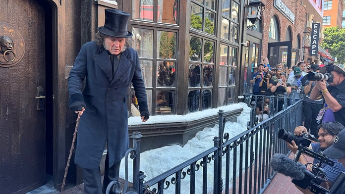 Johnny Depp in full Ebenezer Scrooge costume with nose prosthetic, black cape and top hat at the Paramount activation at San Diego Comic-Con 2026
