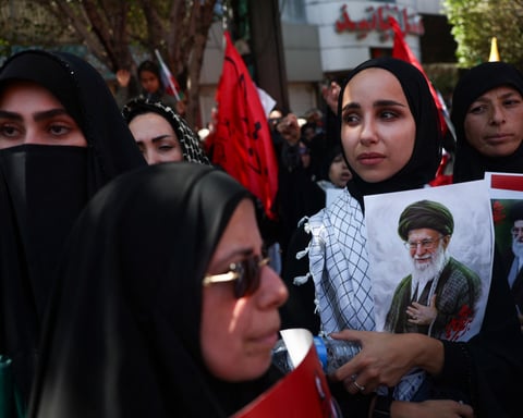 Mourners hold images of Iran's slain Supreme Leader Khamenei on burial day in Mashhad