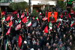 People gather around a portrait of Iran's Supreme Leader Ali Khamenei during a demonstration in Tehran following the collapse of the Islamabad MoU.