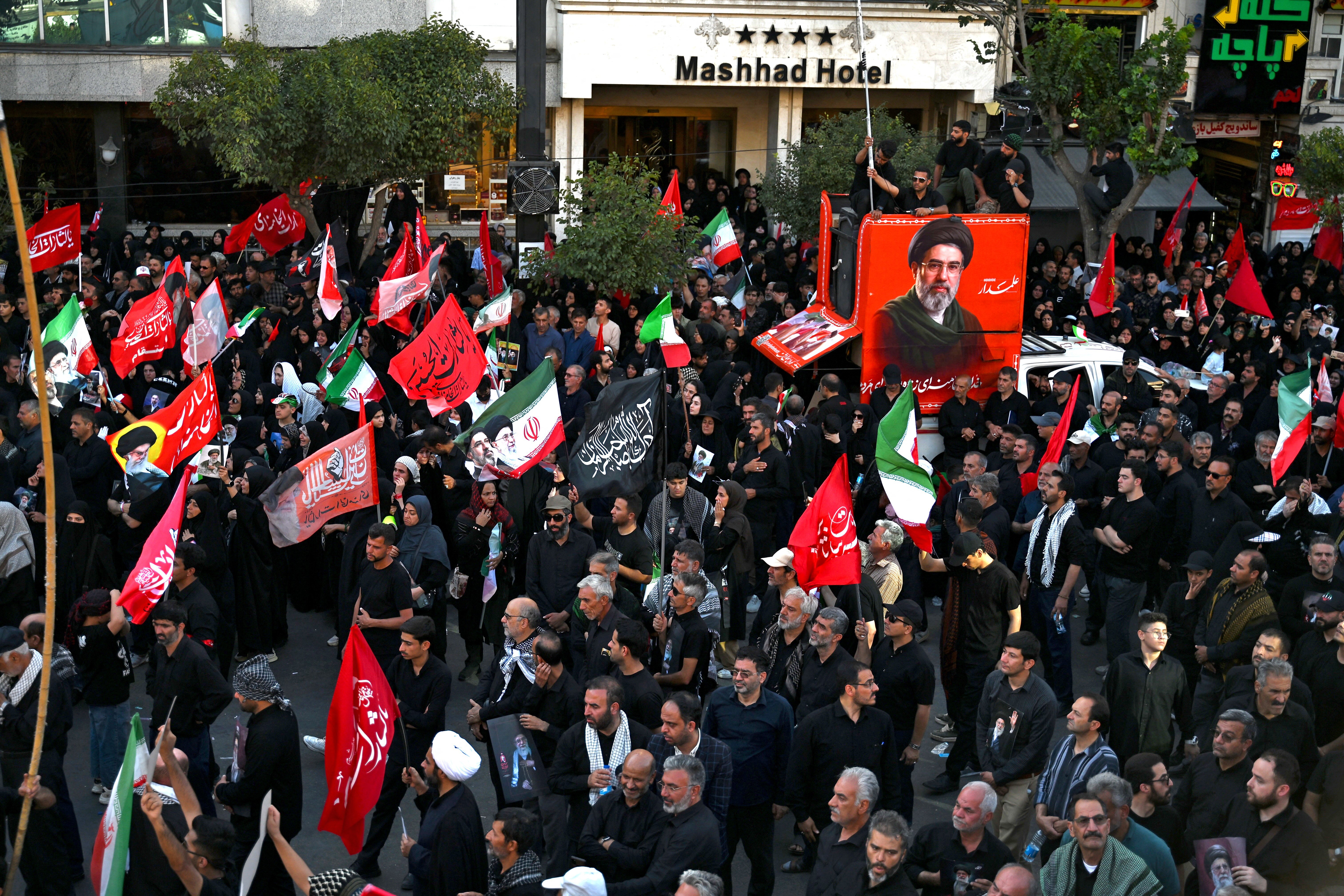 People gather around a portrait of Iran's Supreme Leader Ali Khamenei during a demonstration in Tehran following the collapse of the Islamabad MoU.
