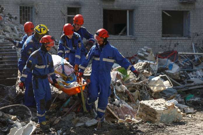 Emergency rescuers recover a victim from debris at a damaged apartment building in Kyiv's Darnytskyi district following Russia's overnight missile and drone attack, July 2, 2026