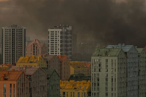 Smoke and flames rise over a Kyiv residential district during Russia's predawn ballistic missile barrage on July 11 2026