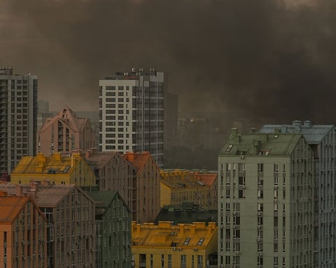 Smoke and flames rise over a Kyiv residential district during Russia's predawn ballistic missile barrage on July 11 2026