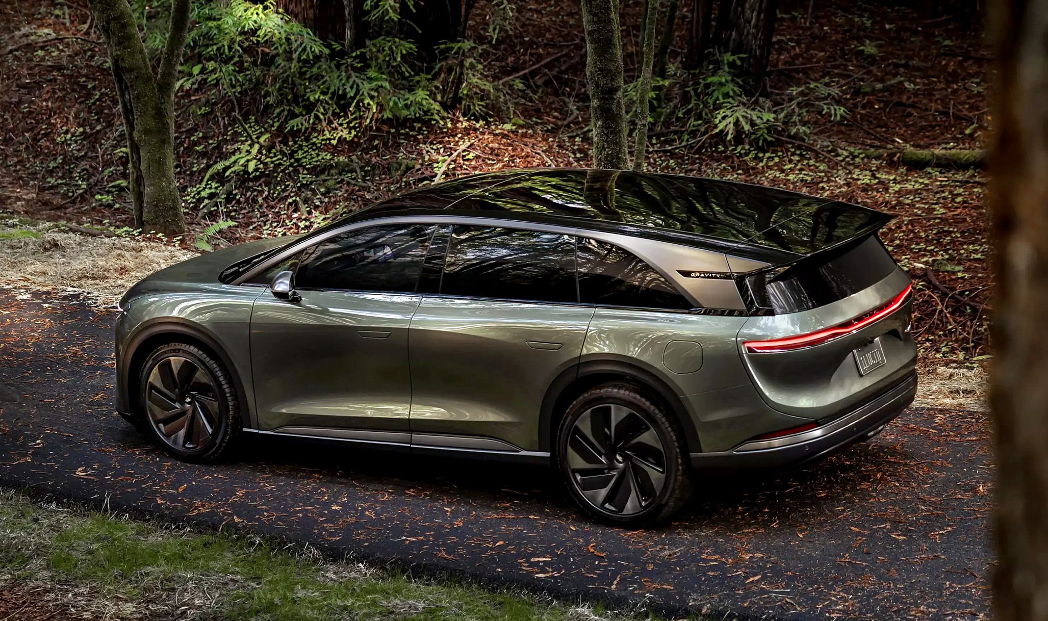 Lucid Gravity SUV parked in a forest setting