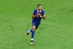 Kylian Mbappe celebrates after scoring his 22nd World Cup goal breaking the all-time record against England in Miami