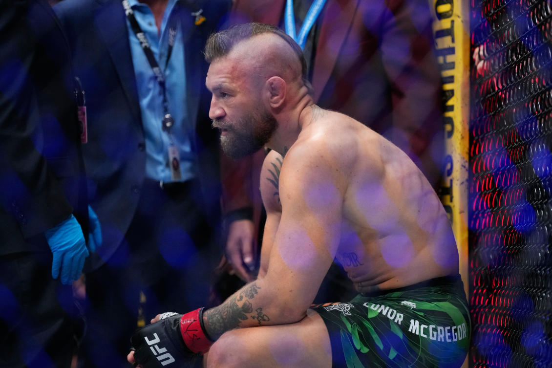 Conor McGregor attempts a kick against Max Holloway at UFC 329 in Las Vegas, resulting in a knee injury that ended the fight in 69 seconds