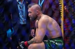 Conor McGregor attempts a kick against Max Holloway at UFC 329 in Las Vegas, resulting in a knee injury that ended the fight in 69 seconds