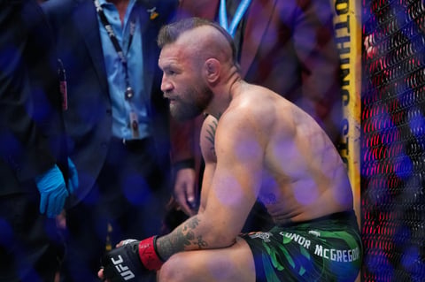 Conor McGregor attempts a kick against Max Holloway at UFC 329 in Las Vegas, resulting in a knee injury that ended the fight in 69 seconds