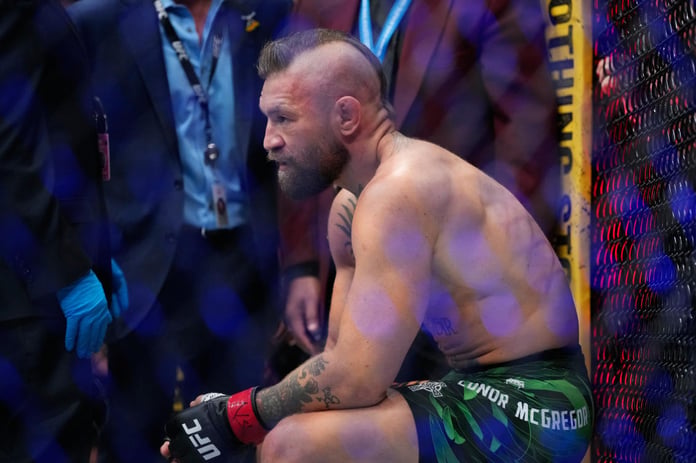 Conor McGregor attempts a kick against Max Holloway at UFC 329 in Las Vegas, resulting in a knee injury that ended the fight in 69 seconds