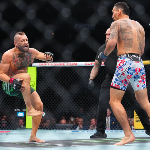 Conor McGregor reacts after suffering a right knee injury against Max Holloway at UFC 329