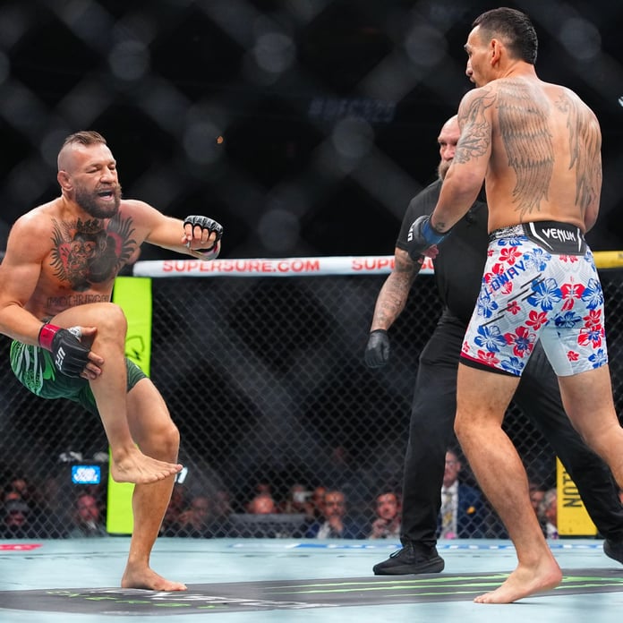 Conor McGregor reacts after suffering a right knee injury against Max Holloway at UFC 329