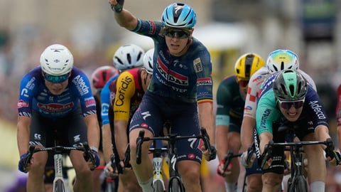 Tim Merlier raises arms after winning Tour de France Stage 12 sprint in Chalon-sur-Saone