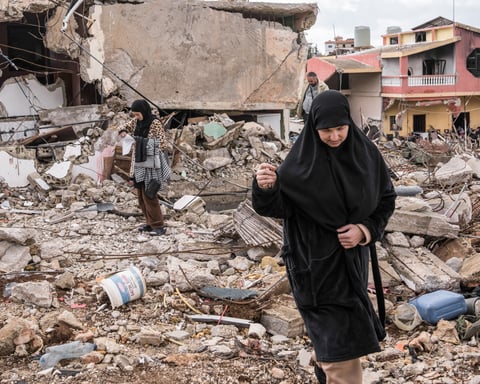 Civilians outside their destroyed homes in Naqoura, southern Lebanon after Israeli military offensive