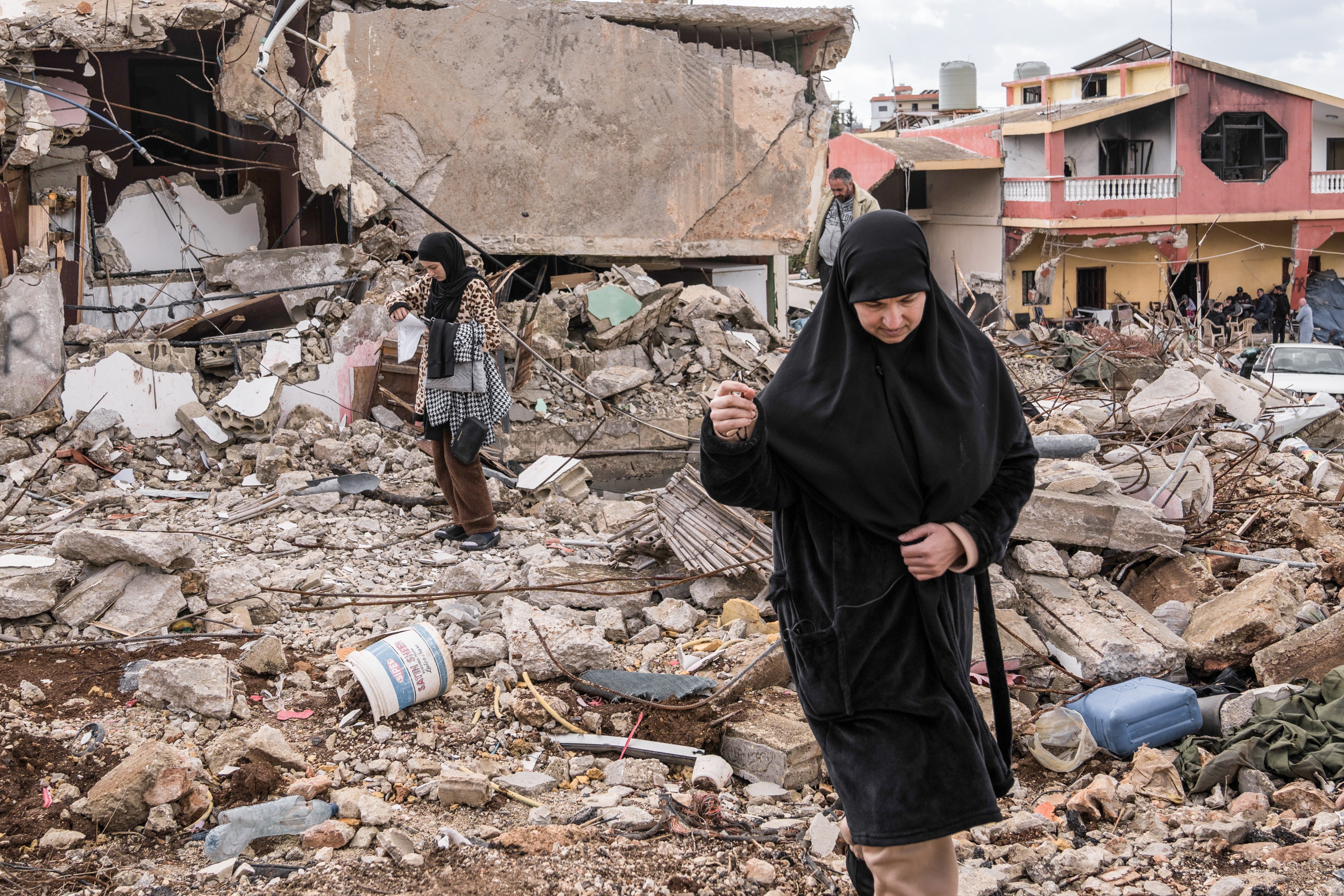 Civilians outside their destroyed homes in Naqoura, southern Lebanon after Israeli military offensive