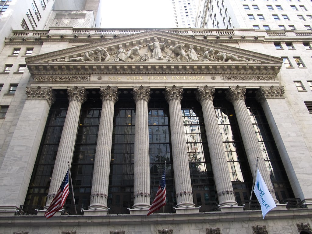 New York Stock Exchange building facade on Wall Street with Corinthian columns and NYSE Euronext banner