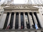 New York Stock Exchange building facade on Wall Street with Corinthian columns and NYSE Euronext banner