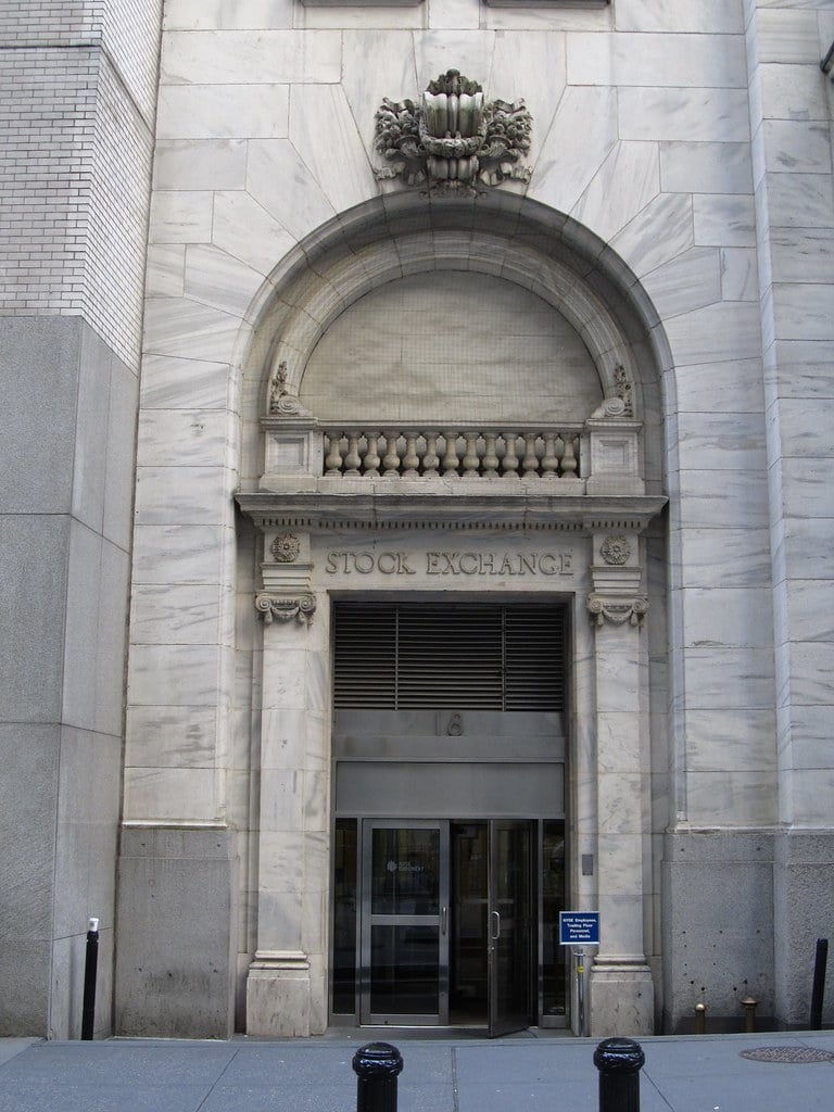 Stock exchange entrance door with carved inscription at the New York Stock Exchange on Wall Street