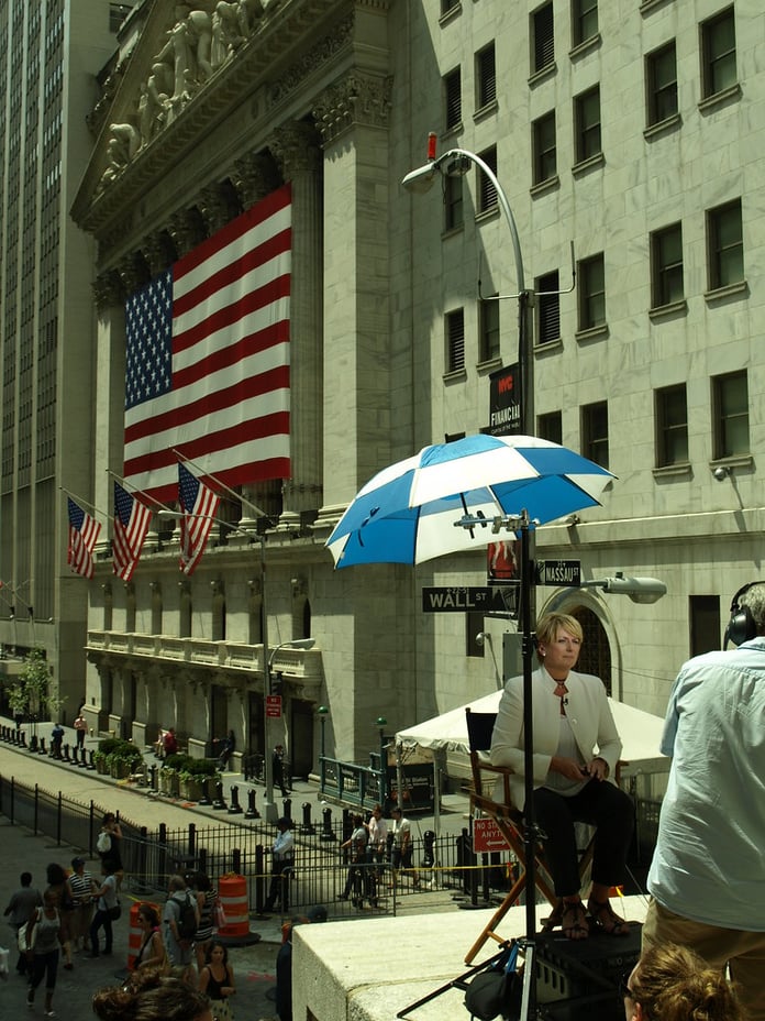 NYSE trading floor with traders and market screens representing Goldman Sachs private markets platform