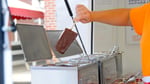 Vendor preparing frozen chocolate-dipped cheesecake on a stick at Ohio State Fair 2026