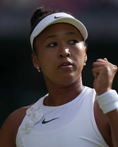 Naomi Osaka celebrates after beating Aryna Sabalenka at Wimbledon 2026