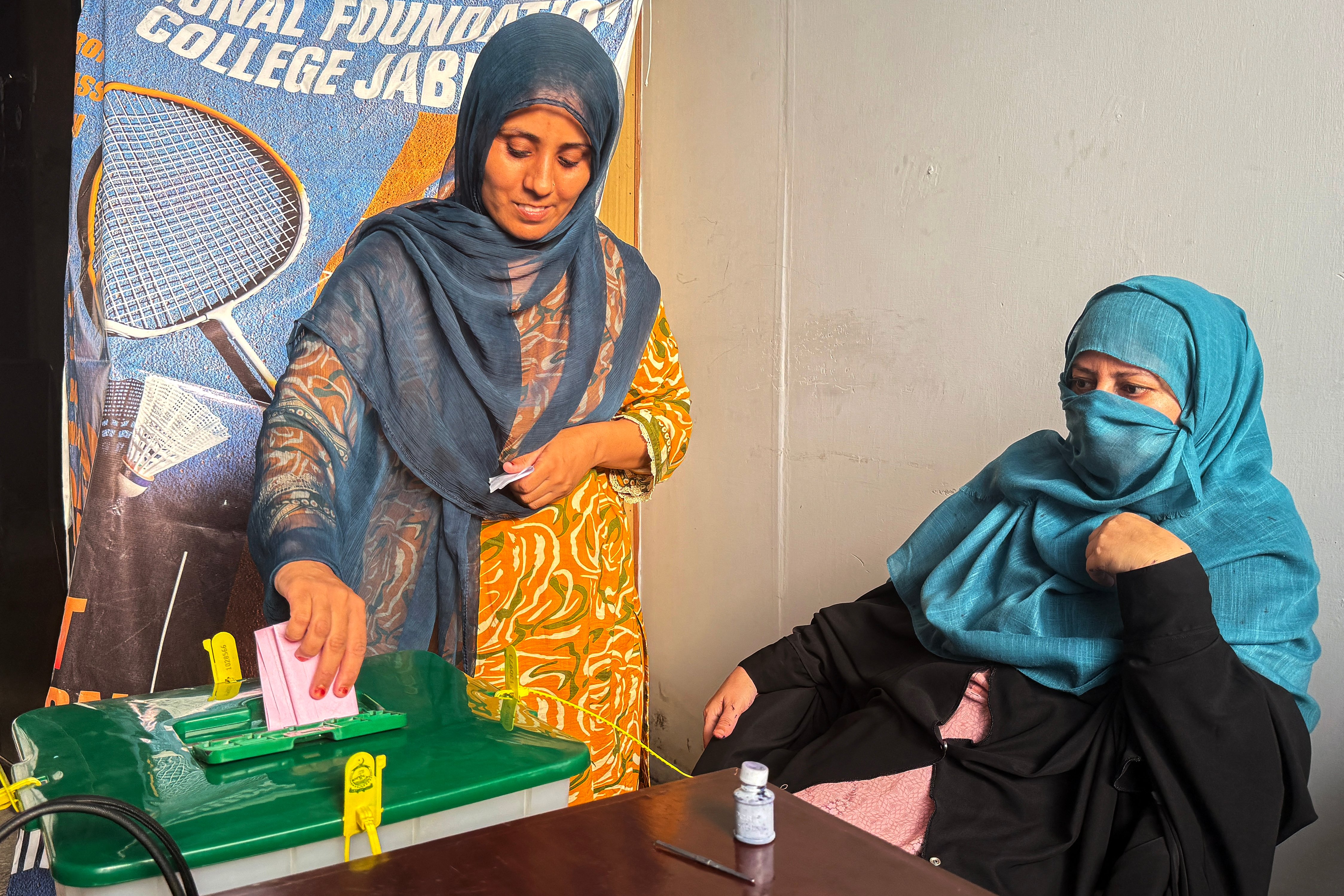 Voters and security forces during the Pakistan-occupied Kashmir election amid protests and clashes