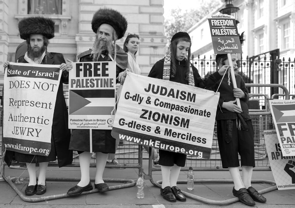 Demonstrators holding Palestinian flags and solidarity banners at a protest against Israeli military operations in Gaza