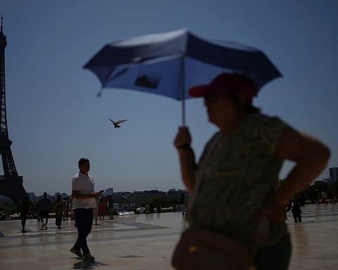 Crowds at the Trocadero plaza near the Eiffel Tower during the Paris heatwave