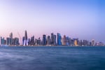Doha Bay waterfront and West Bay skyline at twilight, Qatar, where Iranian, Qatari, and Pakistani officials held indirect talks on the Islamabad Memorandum of Understanding