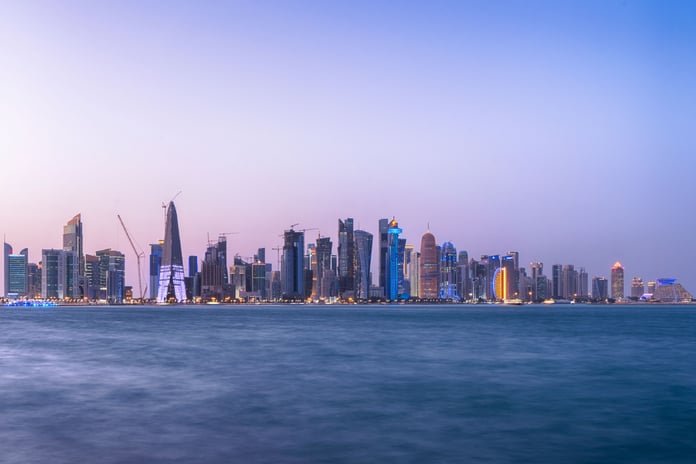 Doha Bay waterfront and West Bay skyline at twilight, Qatar, where Iranian, Qatari, and Pakistani officials held indirect talks on the Islamabad Memorandum of Understanding