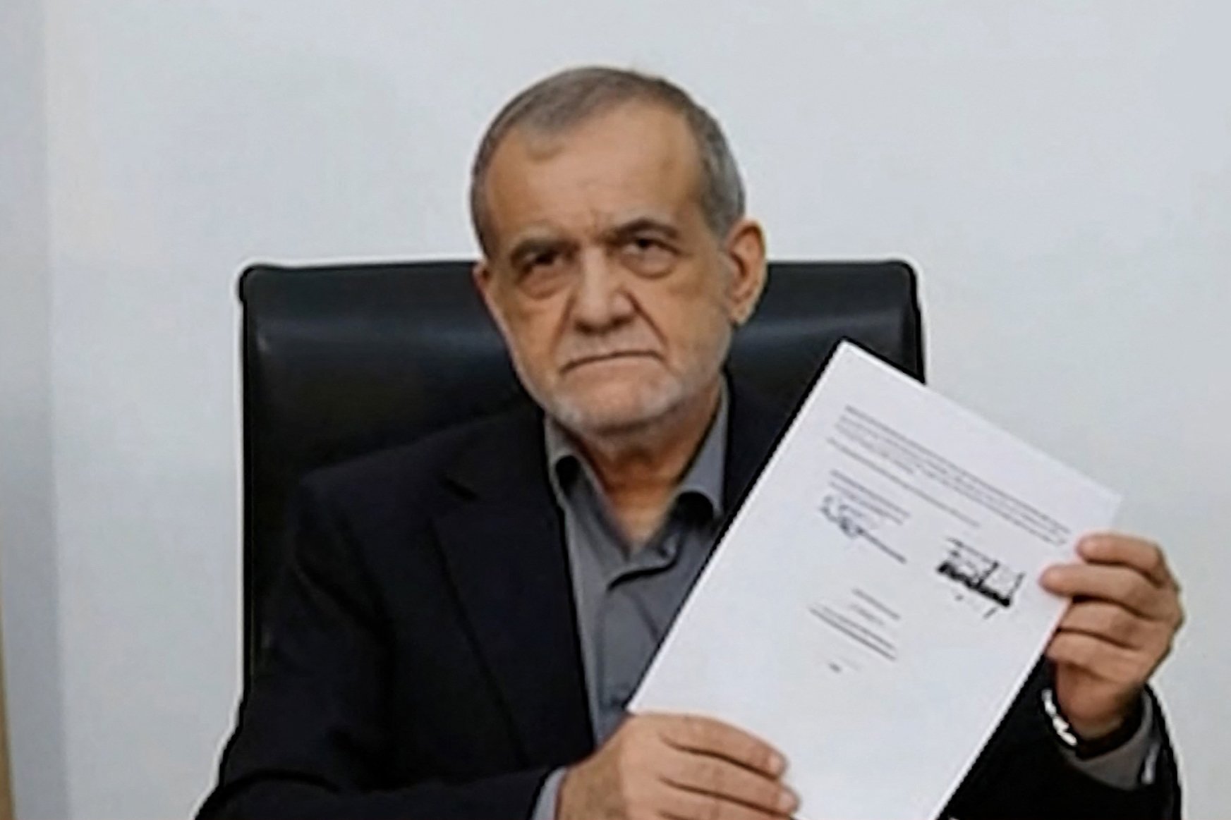 Iranian President Masoud Pezeshkian displays the signed Islamabad Memorandum of Understanding June 2026
