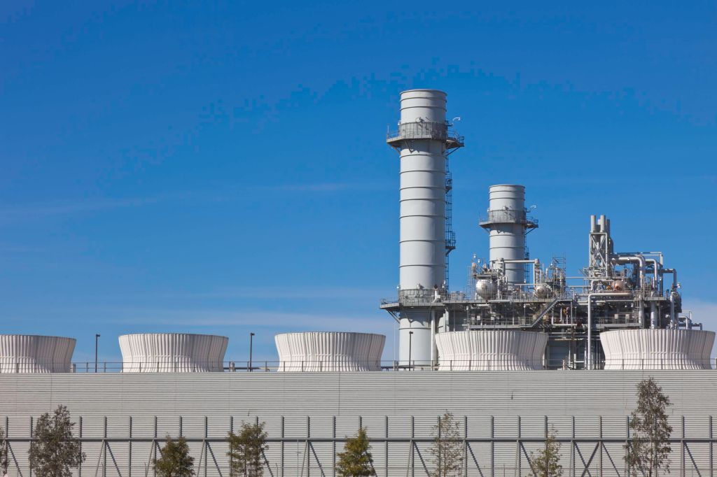 Natural gas power plant cooling towers representing AI data center energy strain in New York