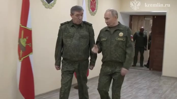 Russian President Vladimir Putin speaks with Chief of the General Staff Valery Gerasimov at a command post during the Russian military operation in Ukraine