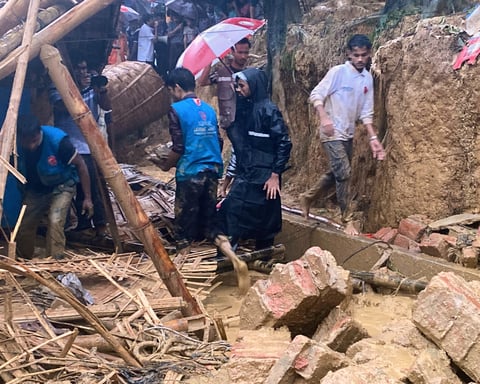 Rescue workers at the site of a landslide that struck a Rohingya girls' school at Cox's Bazar Bangladesh