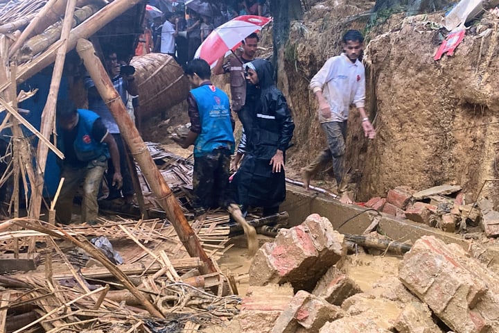 Rescue workers at the site of a landslide that struck a Rohingya girls' school at Cox's Bazar Bangladesh