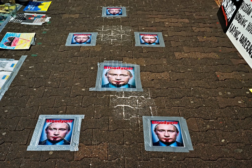 Protesters outside Russian Embassy in Frankfurt holding Ukraine flags and anti-war signs